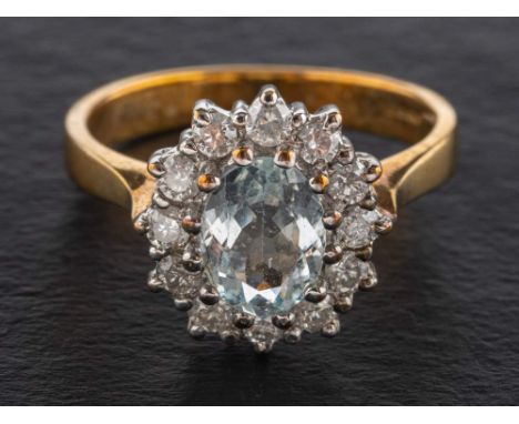 A 9ct gold, aquamarine and round brilliant-cut diamond cluster ring,: estimated aquamarine weight ca. 0.85ct, total diamond w