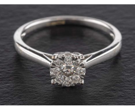 A round brilliant-cut diamond cluster ring,: the central diamond estimated weight ca. 0.10ct, G-H colour, SI1 clarity, the re