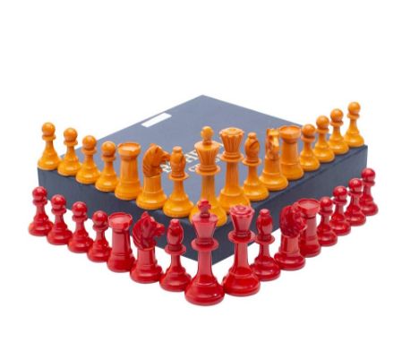 A bakelite Staunton pattern chess set: one side red, the other yellow, the king 10cm high, the pawn 5.25cm.