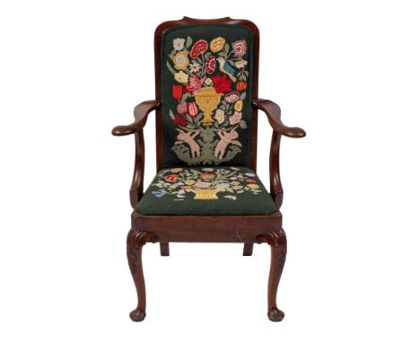 A mahogany and upholstered elbow chair in George II style,: the rectangular backrest with outscrolled centre to the toprail; 