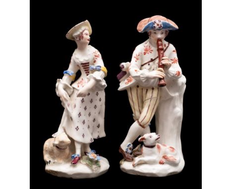 A pair of Bow figures of a shepherd and shepherdess: the shepherd boy playing the recorder, a lamb at his feet and on tree st