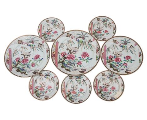 A Chinese famille rose part service: painted with pheasants, auspicious objects and peony within scroll-shaped panels, Qianlo