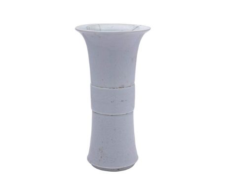 A Chinese blue and white bowl and a blanc-de-chine 'anhua' decorated beaker vase: the bowl painted with elegant ladies and ch
