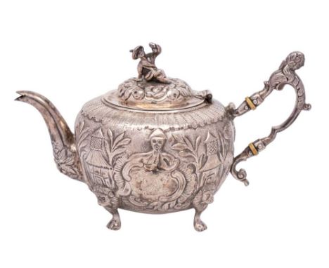 A chinoiserie design silver teapot, unmarked: bears crest and armorial, of circular outline, the domed hinged lid with figura