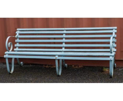 A wrought iron and slatted wood garden bench, early 20th century,: the scrolling arms descending into supports with scrolled 