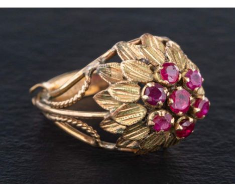 A mid-20th century, ruby dress ring of stylised flowerhead design,: length of ring head 2.3cm, ring size L, total weight ca. 