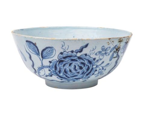 An English delftware bowl: the exterior painted in blue with large rose sprays, the interior with foliage, circa 1760, 27cm [