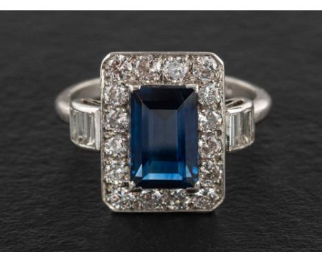 A rectangular step-cut sapphire, baguette and round-brilliant cut diamond cluster ring,: estimated sapphire weight ca. 1.90ct