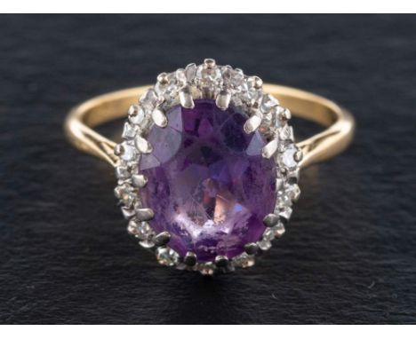 An amethyst and single-cut diamond cluster ring,: estimated diamond weight ca. 0.14ct, stamped '18CT', ring size U, length of