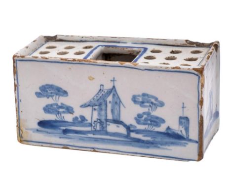 An English delftware flower brick: of small size, the top pierced with three rows of three holes around a central square aper