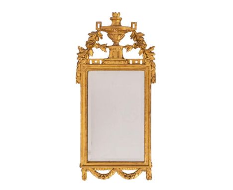 An Italian carved and giltwood framed wall mirror in Neoclassical taste, circa 1875,: with openwork surmount of swagged twin 