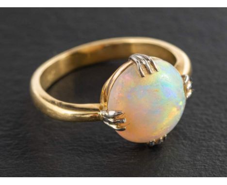 A circular, cabochon-cut, opal ring,: estimated opal weight ca. 2.50cts, stamped '18CT', length of ring head ca. 1.2cm, ring 