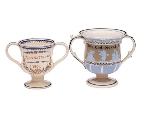 A mid 19th century creamware frog loving-cup and one other in early 19th century style: the first with three interior frogs, 