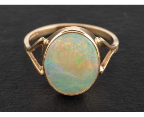 A 9ct gold, cabochon-cut opal ring,: estimated opal weight ca. 3.10cts, with partial hallmarks for Birmingham, length of ring