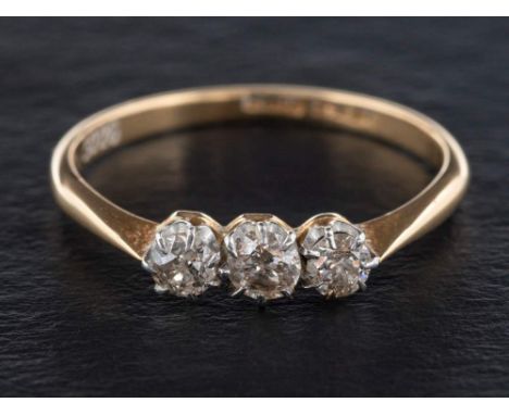 A round, brilliant-cut, three-stone diamond ring,: estimated total diamond weight ca. 0.45cts, K-L colour, P1-2 clarity, ring