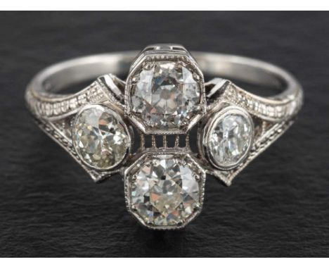 An old-cut diamond cluster ring of quatrefoil design,: estimated total diamond weight ca. 1.50ct, I-J colour, SI2-P1 clarity,