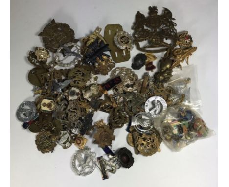 Over 80 military cap badges and pins including Lowland Regiment, RAF, Royal Army Medical Corp and royal Artillery etc. 