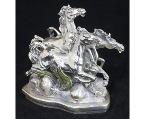 Silvio Ottaviani.  Three galloping horses, loaded silver gilt composition with yellow enamel, 22cm high, signed and labelled 