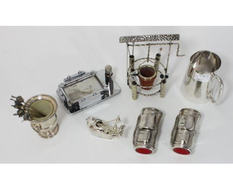 A collection of assorted silver-plated novelty cocktail stick holders including a well, a duck and a pair of golf bags etc. t