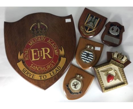 A large shield plaque 'Royal Military Academy Sandhurst Serve to Lead', together with a ceramic ships crest 'Alacrity', mount