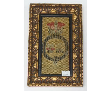 A framed and glazed embroidered silk panel depicting a Royal crest, reputedly from William IV's carriage, paper labels to ver