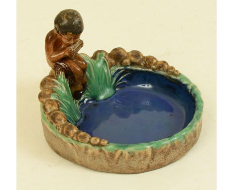 A Royal Doulton bibelot of a faun playing pan-pipes, impressed marks to base with number 8753, approx. 12cm high x 15cm diame