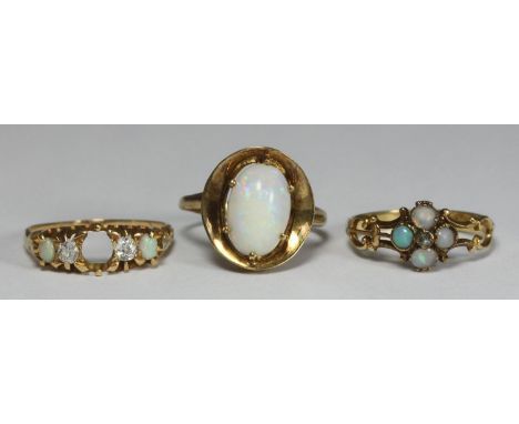 A 14ct gold ring marked '585' with oval opal set in oval dished setting, 4.2g, together with an 18ct gold ring set with four 