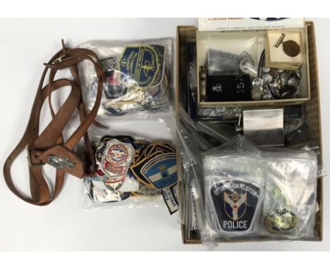 A large quantity of Police related collectables including an ARP police whistle, US cloth badges, Metropolitan police horse's