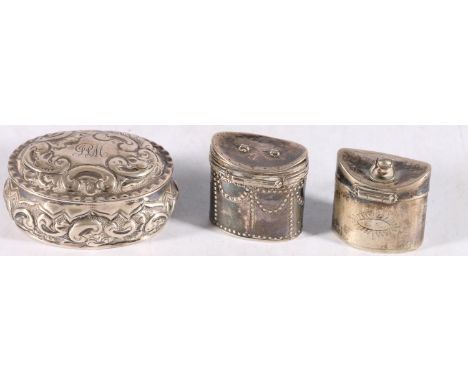 Two antique silver hinged pill boxes of cylindrical form, one engraved to the base DRB and a repousse decorated sterling silv