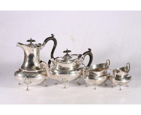 George V sterling silver four piece tea service, with ribbon and garland decorated body, raised on paw supports, William Aitk