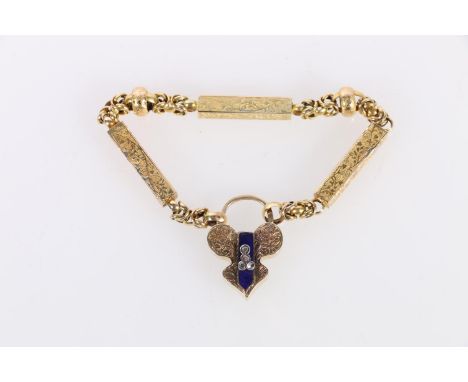Unhallmarked yellow metal fancy padlock set with four diamond chips on an blue enamelled arrow panel, 7.0g and a yellow metal