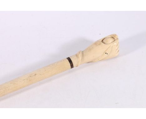 Marine ivory walking stick, the handle in the form of a fist holding a ball, 91cm long. 