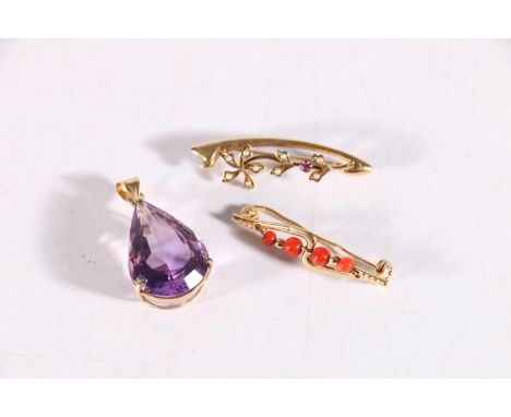 18ct gold and coral brooch, 2.9 grams, a 15ct gold floral pearl and ruby set brooch, 2.3g and a 14k yellow gold facted amethy