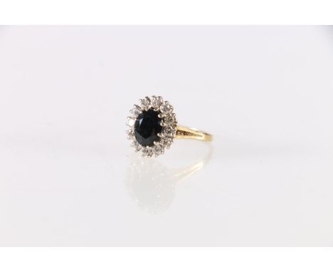 Gold diamond and jet dress ring, the central faceted jet stone encircled by twelve round diamonds, hallmarks rubbed, maker 'J