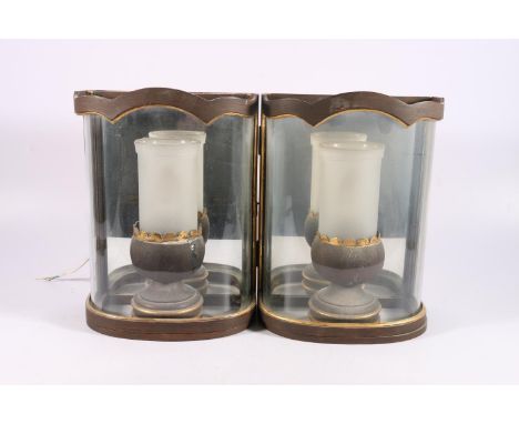 A pair of electric wall lanterns, probably by Colefax and Fowler, of demi lune shape with curved glass fronts holding egg cup