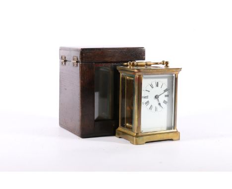 Brass four glass carriage clock, with carry handle and white dial with Roman numerals, the back plated initialled 'ACC', 10.5