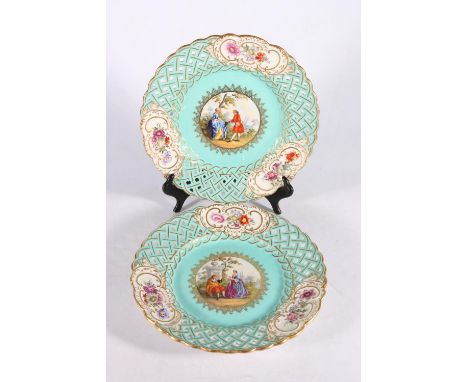 Pair of Continental porcelain cabinet plates with reticulated lattice borders, central vignettes of Classical scenes on a aqu