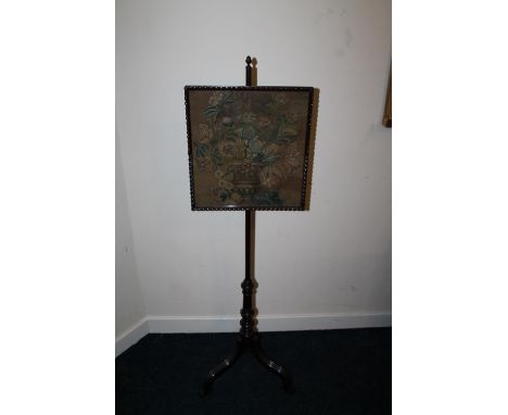 Victorian mahogany pole screen raised on needed tripod supports, the screen on embroidered planter with flowers, 133cm tall. 
