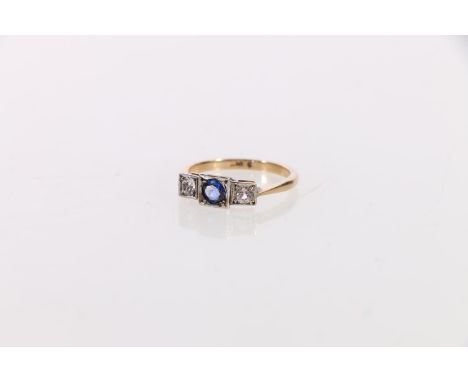 Gold sapphire and diamond three stone ring in the Art Deco manner, the central faceted sapphire flanked by two diamonds each 