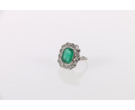 Diamond and emerald cocktail ring, the central faceted emerald surrounded by fourteen diamonds, size N, 4.8g. Emerald is 11mm