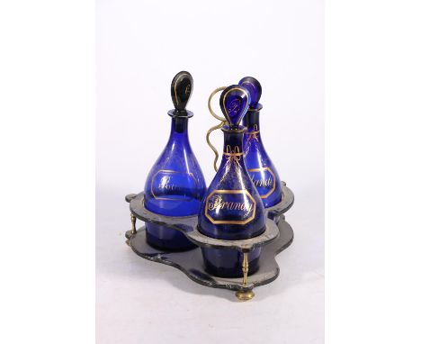 Antique trio of Bristol blue decanters with gilt decoration of faux decanter labels for Rum, Hollands and Brandy on stand, 26