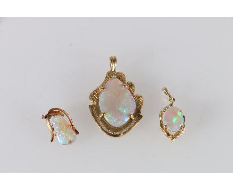 18ct gold mounted opal and diamond pendant 9.7g, another 3.0g and an unhallmarked yellow metal mounted opal pendant 1.6g. (3)