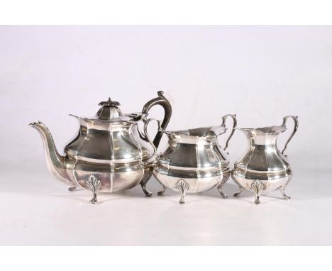 George V sterling silver three piece tea service, the reeded body on shaped cabriole legs, Albert Henry Thomson, Sheffield, 1
