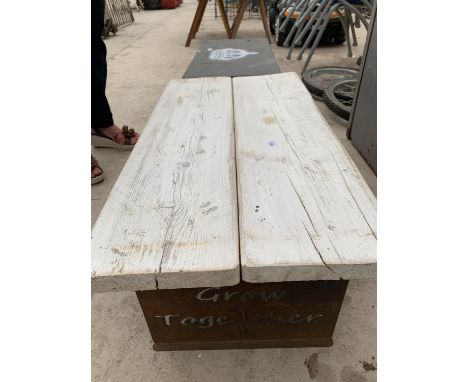 A WOODEN BENCH ON METAL SUPPORTS 'LETS GROW TOGETHER' 