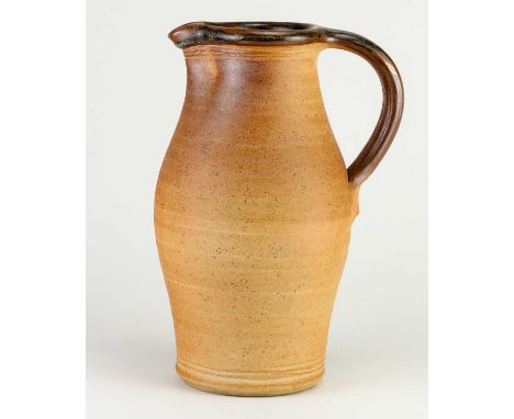 † JOHN LEACH (1939-2021) for Muchelney Pottery; a tall stoneware jug with toasted unglazed exterior and tenmoku breaking to k