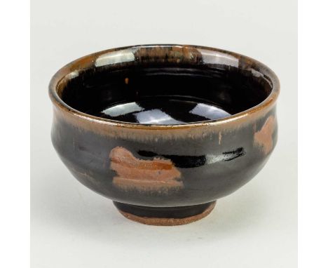 † JIM MALONE (born 1946); a stoneware bowl covered in tenmoku breaking to kaki glaze with wax resist decoration, impressed JM