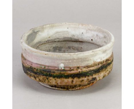 † ROBIN WELCH (1936-2019); a small stoneware bowl covered in bands of grey and mottled green glaze separated by a thin band o