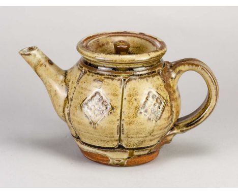 † MIKE DODD (born 1943); a stoneware teapot covered in green ash and iron glaze with incised and impressed decoration, impres