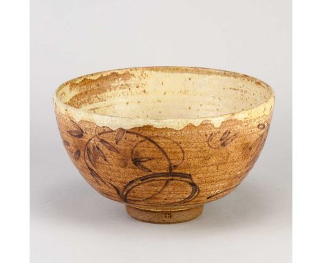 † HENRY HAMMOND (1914-1989); a deep stoneware bowl covered in mottled iron and oatmeal glaze with iron floral decoration to t