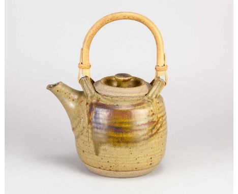 † MICHAEL CASSON (1925-2003); a stoneware teapot with cane handle covered in green ash glaze with tenmoku brush decoration, i